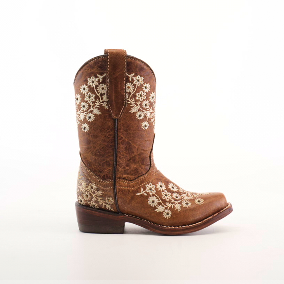 The Abril Studs Orix Snip Toe is a single brown cowboy boot with detailed white floral embroidery on the shaft and foot, showcasing a snip toe design, set against a plain white background.