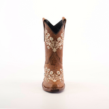 The Abril Studs Orix Snip Toe boot, set against a white background, showcases intricate white floral embroidery on the front and sides of a single brown cowboy boot with a classic snip toe design.