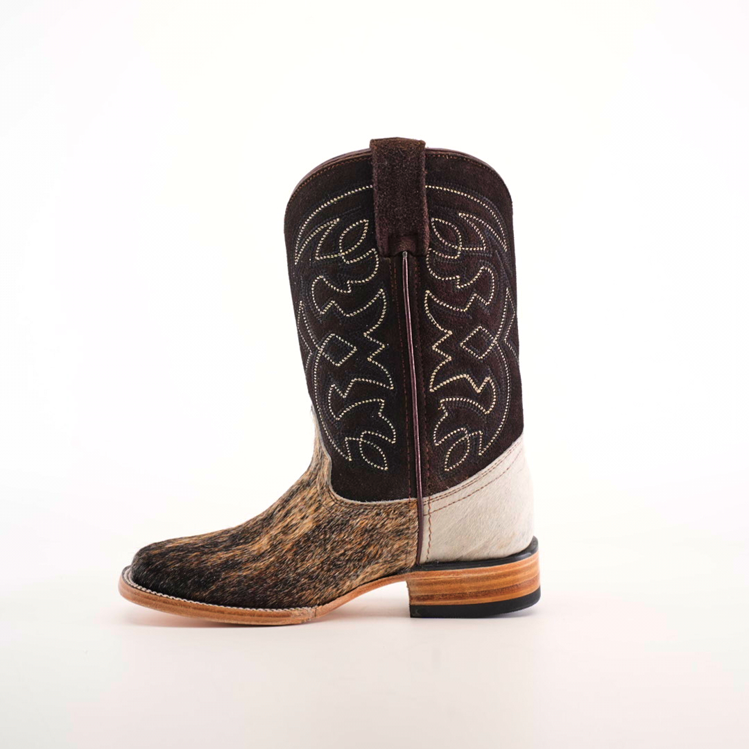 The Cowhide Hair Fawn Square Toe cowboy boot features a dark brown shaft with white stitching, a textured cowhide hair pattern on the lighter brown fawn-finished foot, and a square toe. It has a wooden sole with a low heel, all showcased against a plain white background.