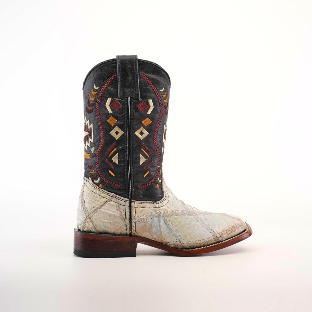 The Exotic American Alligator Patchwork Bone Square Toe boot features a black-and-white alligator skin with red, yellow, and white geometric designs on the shaft and brown patchwork accents on the heel and square toe.