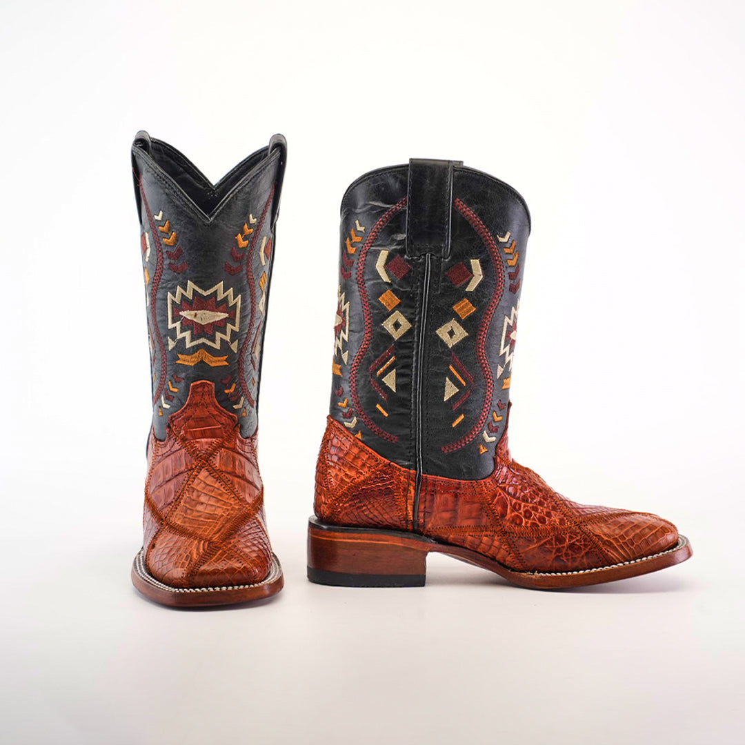 The Exotic American Alligator Patchwork Cogñac Square Toe boots feature black shafts and brown textured alligator leather feet, adorned with colorful geometric embroidery like diamonds and abstract shapes. These cognac boots seamlessly combine classic style with modern flair.