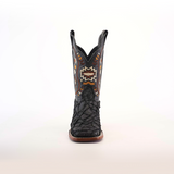 The Exotic Pirarucu Fish Patchwork Matte Black Square Toe boot features intricate orange, brown, and white embroidery. Crafted from authentic leather, it boasts a textured lower section with contrasting shaft stitching against a plain white backdrop.