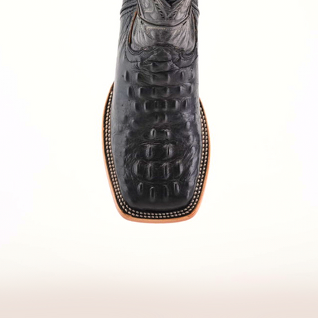 The Caiman Hornback Print Black Square Toe boot features a textured black leather with a square toe and stitched edging, crafted from premium materials, set on a plain light background.