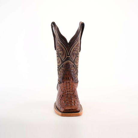 Front view of a single luxury boot, named Caiman Hornback Print Chocolate Square Toe, crafted in brown caiman hornback print with intricate stitching and a pointed toe, set against a pristine white background.