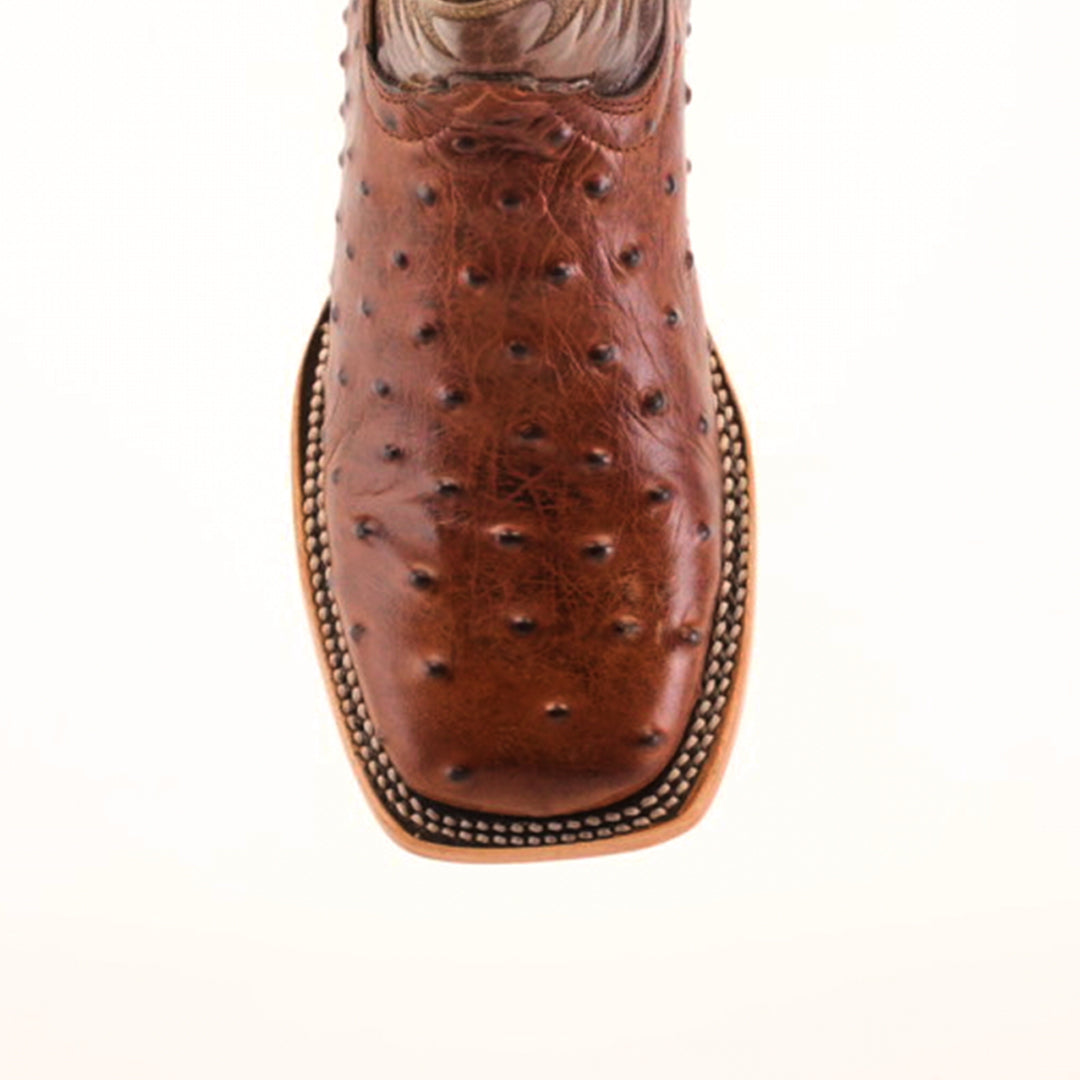 Close-up of the Karoo Ostrich Print Chocolate Square Toe cowboy boot, made from premium materials, features a distinct bumpy texture and intricate edge stitching, set against a plain light background.