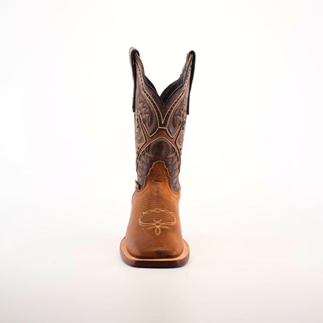 The Cater Honey Square Toe cowboy boot, made from premium brown leather, stands upright on a plain white background. It features intricate stitching and patterns, showcasing superior craftsmanship with a pointed toe and tall shaft adorned with decorative designs.