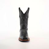 A single black cowboy boot, crafted from premium leather with intricate stitching and a pointed toe, features a Barcelona Black Slip Resistant Sole, captured from the front against a plain white background.