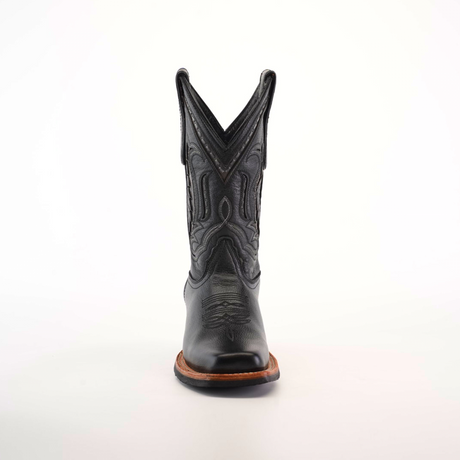 A single black cowboy boot, crafted from premium leather with intricate stitching and a pointed toe, features a Barcelona Black Slip Resistant Sole, captured from the front against a plain white background.