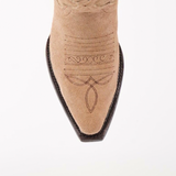 The Madona Sand Suede boot, with intricate brown stitching and a snip toe design, stands out in a close-up on a plain white background.