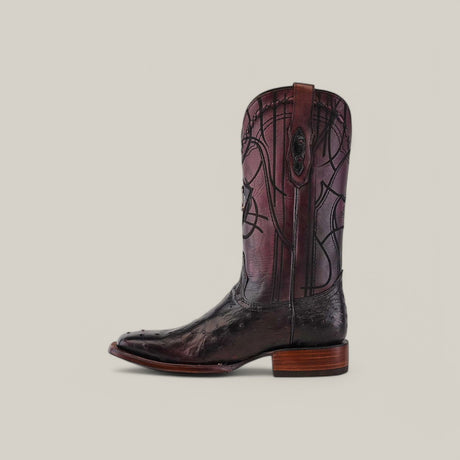 The CU786 cowboy boot features a tall, dark brown leather shaft with intricate stitching and a blackcherry ostrich-textured lower part. It has a wooden heel and exotic laser-engraved details on a light beige background, creating an elegant contrast.