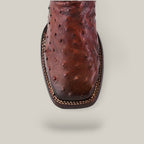 Top view of the Moroni Chestnut Ostrich Laser & Embroidery boot (CU457), showcasing a square toe and detailed stitching, on a plain beige background.