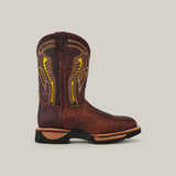 The Floter Brown Composite Toe - E6187 features a rugged design with intricate yellow stitching, a low heel, and deep leather textures. Resting on a light gray background, its Texas Country Work Boots style promises durability and style with a slightly rounded toe.