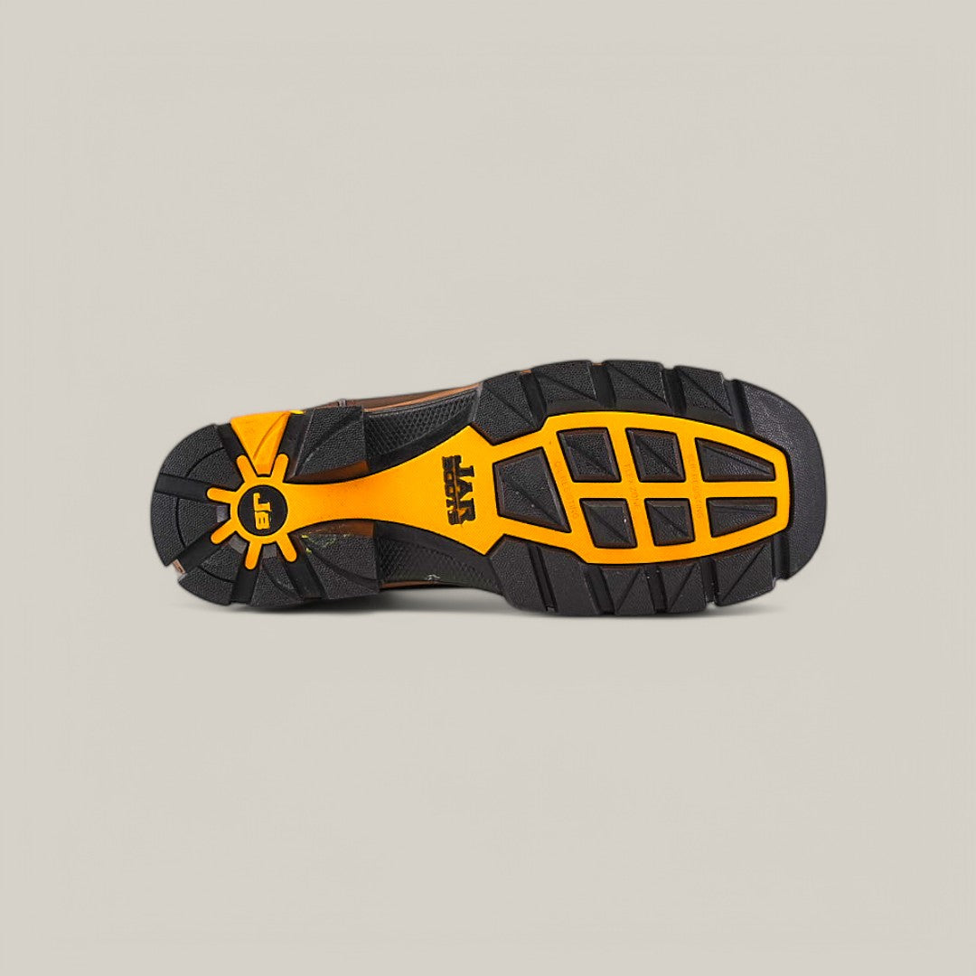 The Amazonas Dark Brown Soft Toe - E6256 shoe features a Texas Country Work Boots-inspired black and orange sole with large grooves and geometric shapes for traction. A yellow stylized sun with EE stands out near the heel against a beige background.