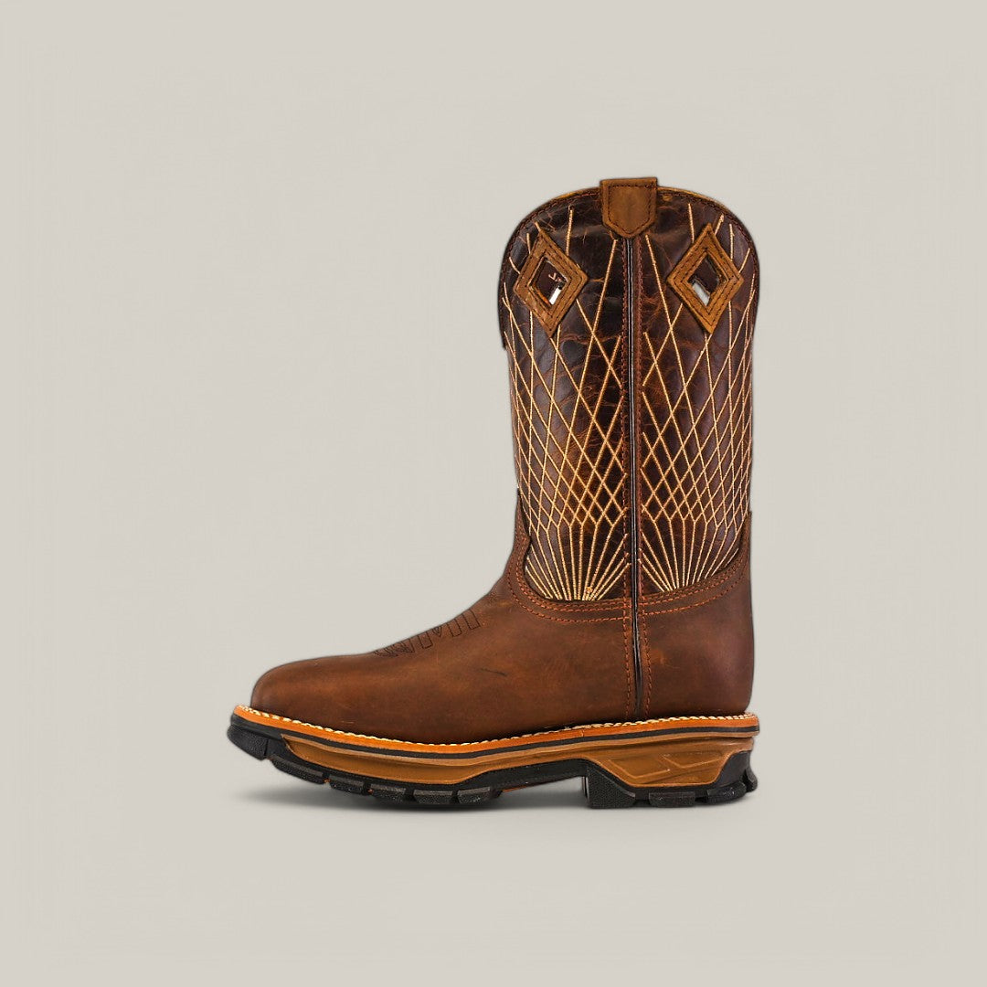 The Amazonas Tanger Composite Toe - E6257 boot features a single brown design with intricate stitching and diamond-shaped patterns. Its black rubber sole and tan midsole highlight its durability, while it stands proudly on a light gray background, embodying rugged elegance.