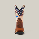 The Aventajado Penac Composite Toe - E6282 cowboy boot showcases a brown leather foot and an upper with stars and stripes in red, white, and blue. It features a prominent blue star on the front against an American flag design, offering both style and durable footwear for any occasion.