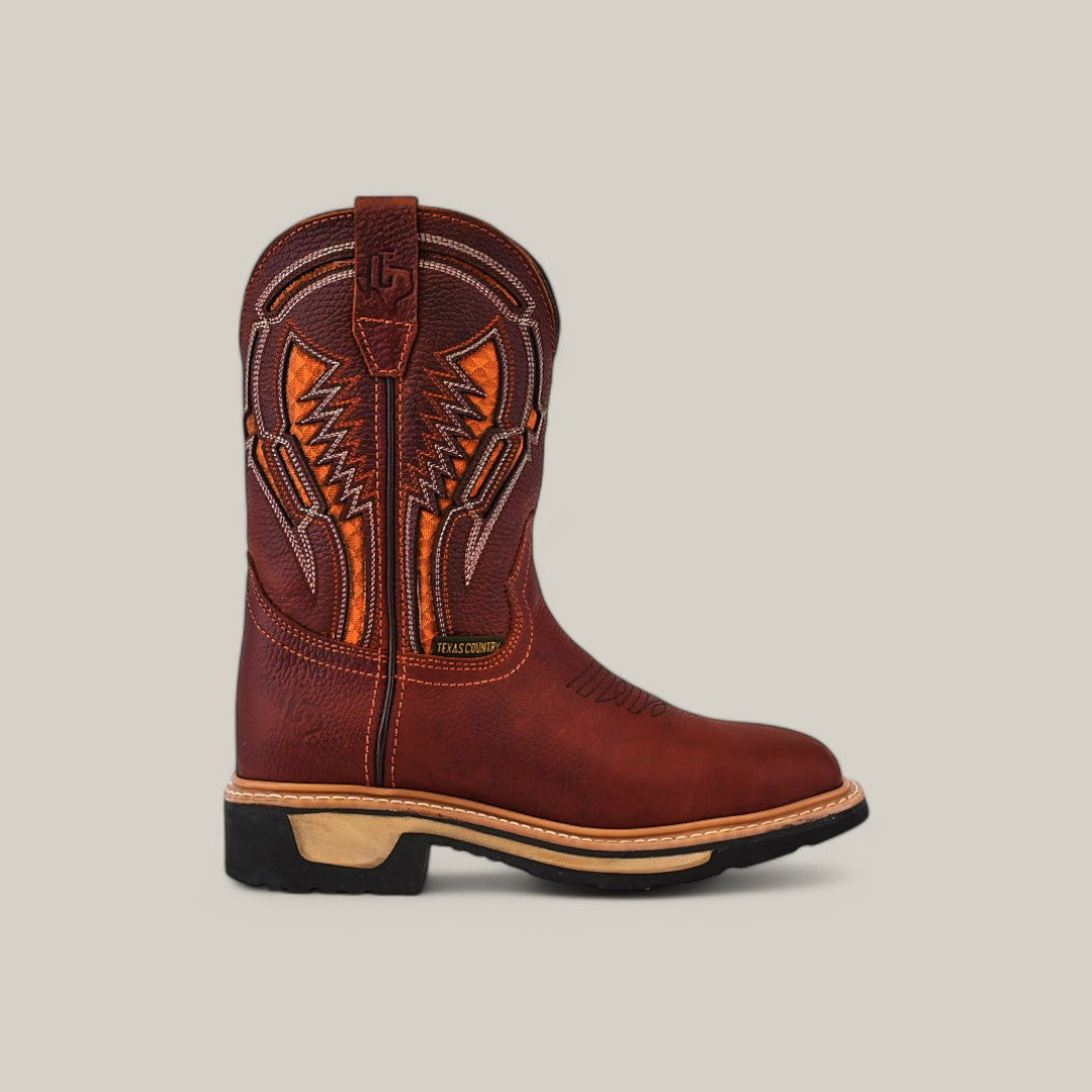 Displayed against a plain light gray background is the Floter Shedron Soft Toe - E6987, a single brown leather boot featuring decorative orange stitching and a durable black heel.