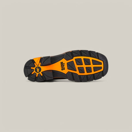 The image highlights the sole of the Crazy Honey Composite Toe - E6296, featuring a rugged orange and black design like Texas Country Work Boots. With a durable tread pattern, circular ray design from the heel, and a centered logo, it promises superior grip and durability.