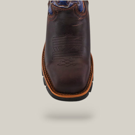 Close-up of the Amazonas Brown Soft Toe - E6002 cowboy boot, featuring decorative stitching on the toe and blue patterned inserts at the top. This boot ensures durability and comfort against a plain, light background.