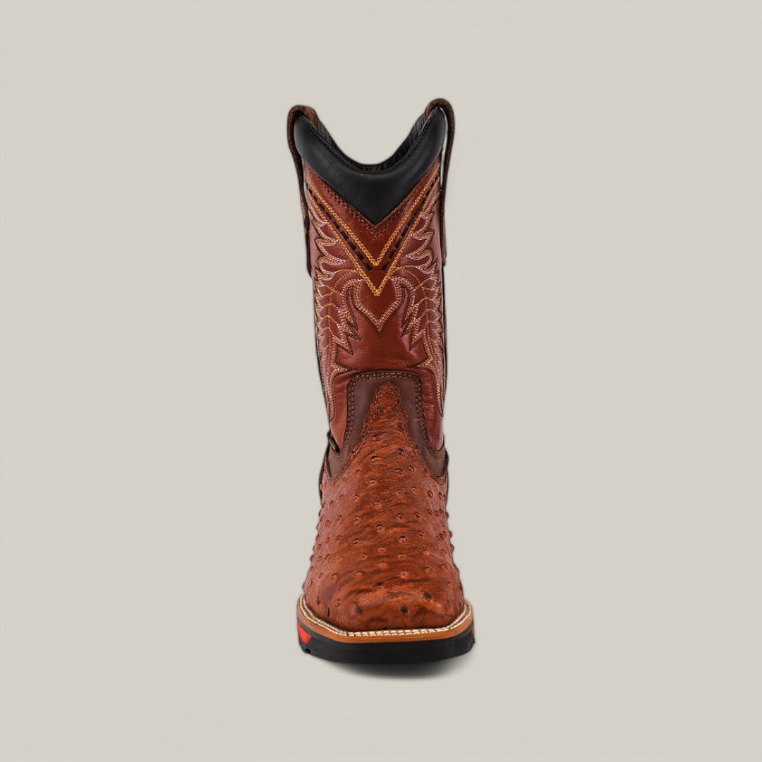 Front view of a single cogñac cowboy boot featuring intricate stitching and ostrich print detailing, showcasing the durability of the Texas Country Ostrich Print Cogñac Soft Toe - E6022, against a plain gray background.