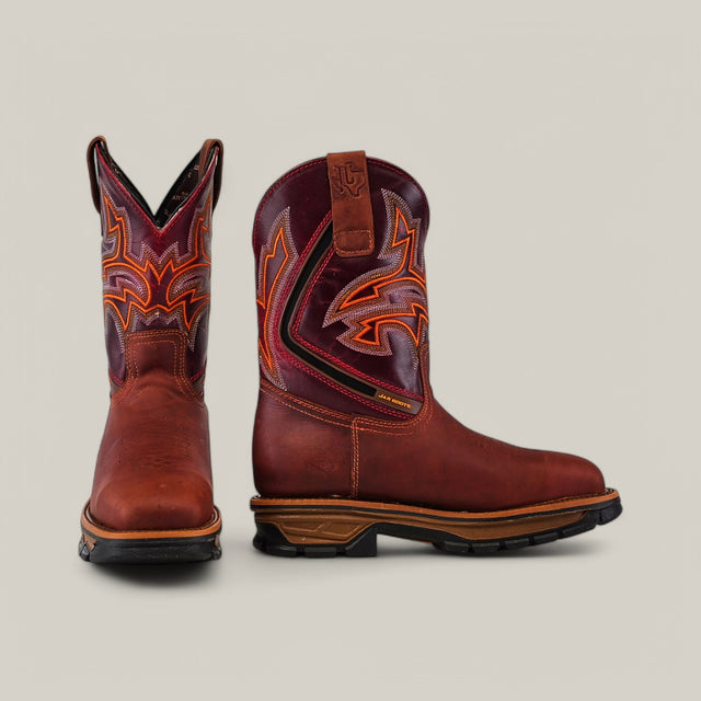 Two Amazonas Cogñac Composite Toe - E6002 boots are positioned against a plain background. The left boot faces forward, and the right shows the side. Both display intricate orange and red stitching on the shaft and a robust black sole, showcasing their durability for hard work.