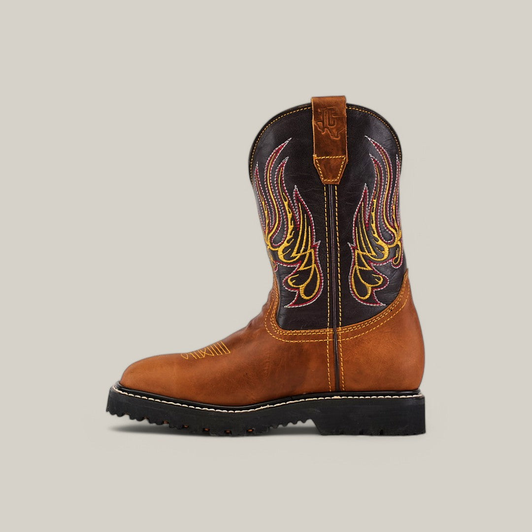 The Golden Ateus Composite Toe - E6016 is a brown cowboy boot adorned with yellow and red flame-like stitching on the shaft. Its designed for durability, featuring a black sole and a convenient pull-tab at the top.