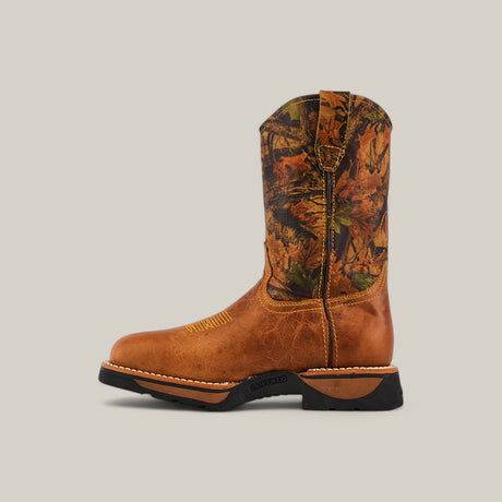 The Alazan Sand Composite Toe - E6081 is a western-style boot with a brown leather foot and camo-patterned shaft. It features decorative toe stitching, a pull tab, and a black rubber sole against a plain beige backdrop, embodying rugged durability.