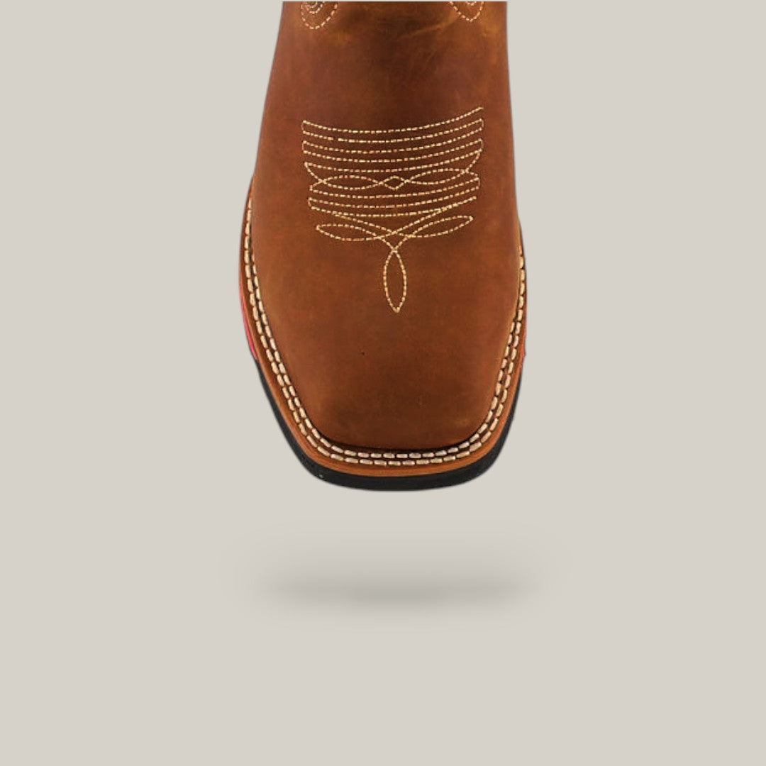 Close-up of the toe of a Texas Honey Composite Toe - E6082 boot, made of durable brown leather with intricate white stitching. The boot casts a subtle shadow on a plain background.