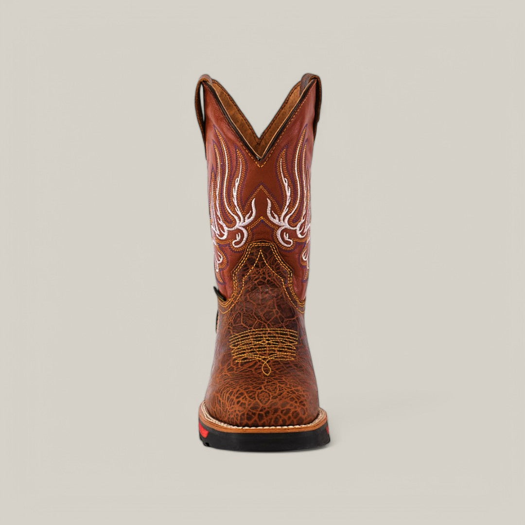 The Jurasic Honey Composite Toe - E6080 cowboy boot is displayed from the front, showcasing detailed white embroidery on the upper shaft and textured leather on the foot. It features a pointed toe and slight heel, blending style with durability against a simple beige backdrop.