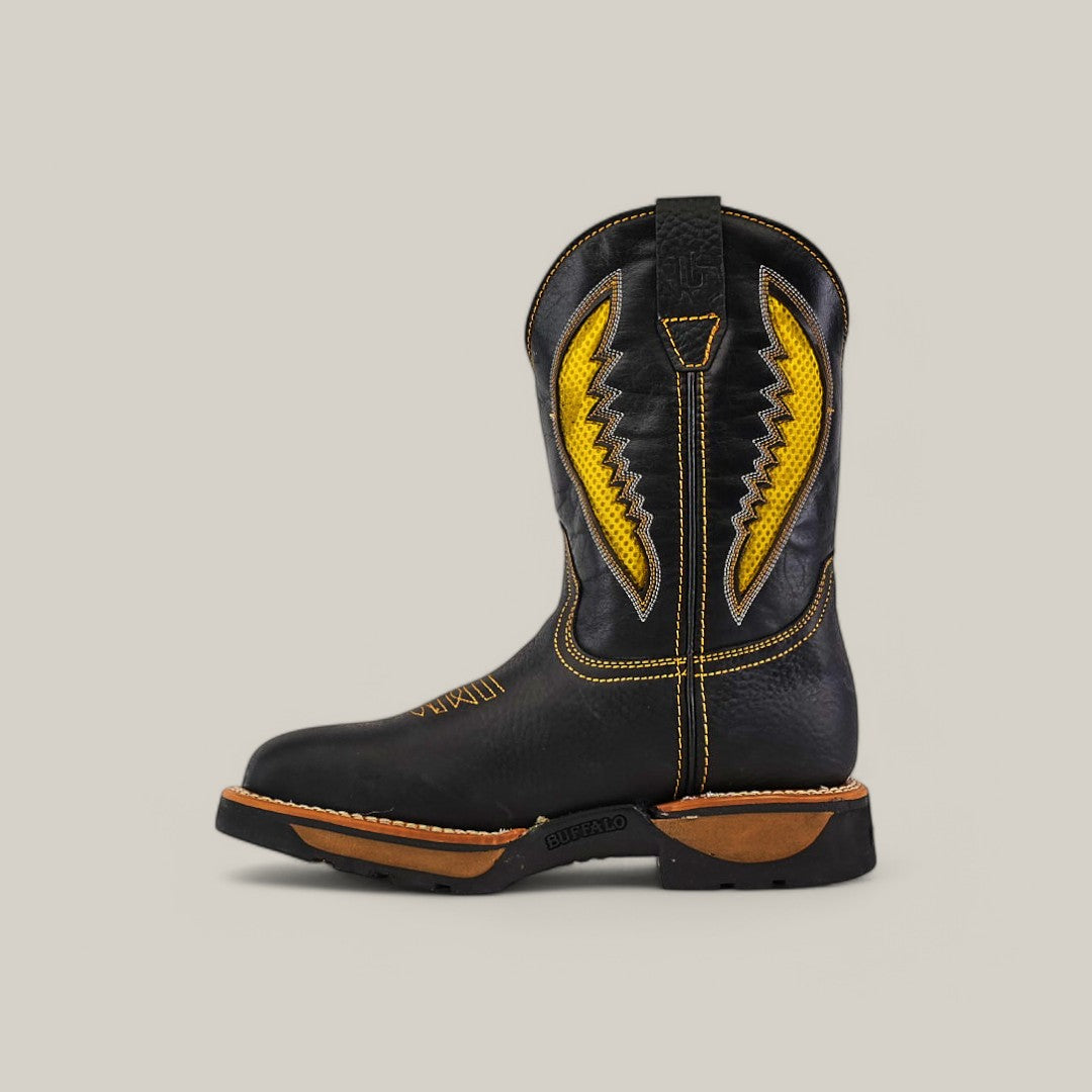 The Rhino Black Composite Toe - E6087 showcases a single black cowboy boot with yellow stitching on the shaft, complete with a pull tab for easy wear. Its dark brown sole with treads ensures durability and comfort, all set against a solid light gray background, embodying classic Texas style.