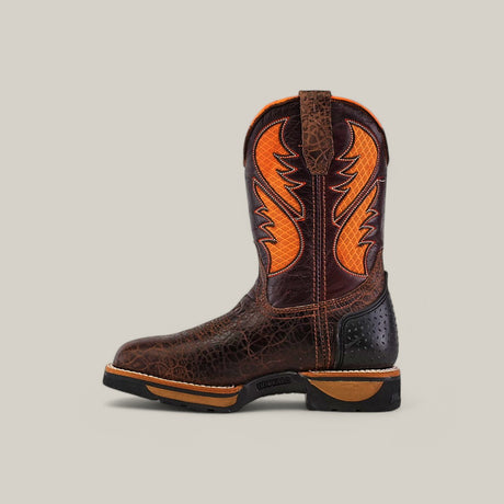 The Jurasic Brown Composite Toe - E6089 is a single brown and orange cowboy boot with a textured pattern, showcasing a bold lightning-like design on the shaft. With a sturdy black sole and pull tab, its perfect for Texas country work boots fans, displayed against a plain beige background.