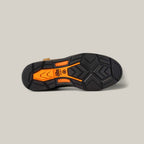 The image showcases the sole of the Workhog Xt H2o Brown - Camposite Toe (10045435) shoe, featuring a black and orange geometric tread pattern with waterproof technology, set against a plain light gray background.