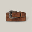 The Exotic Full Quilt Python - Texas Buckle - Tamarindo Belt features a brown snakeskin texture and an ornate silver-toned Texas Buckle with intricate engravings, all displayed against a plain gray background.