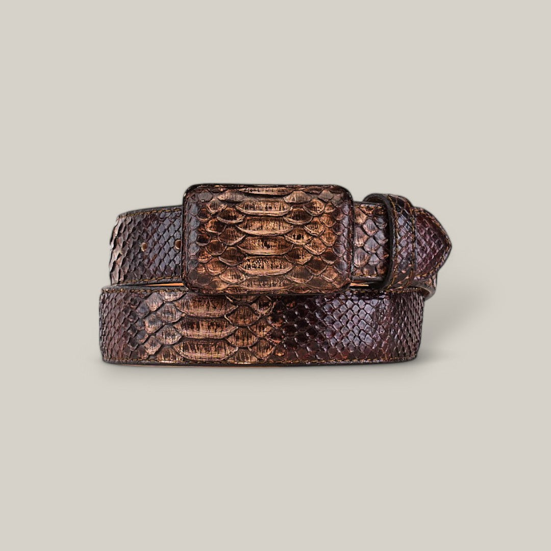 The Exotic Full Quilt Python - Brown Two-Colored Belt exudes luxury with its textured snakeskin pattern and square buckle, stylishly coiled against a plain, light gray background to highlight its exquisite craftsmanship.