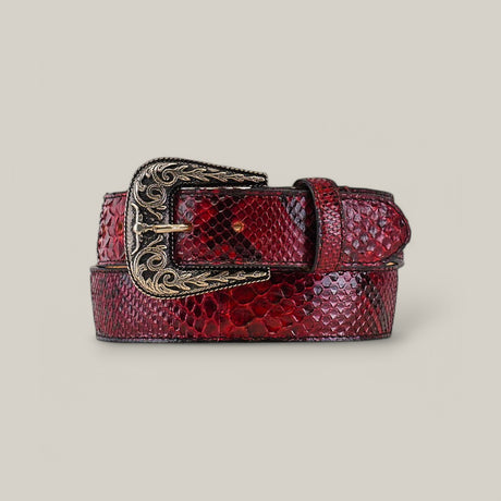 The Exotic Full Quilt Python Ruby Belt features an ornate Texas Buckle with intricate designs. Its rich, textured snakeskin is rolled up, and the belt is displayed against a neutral background.