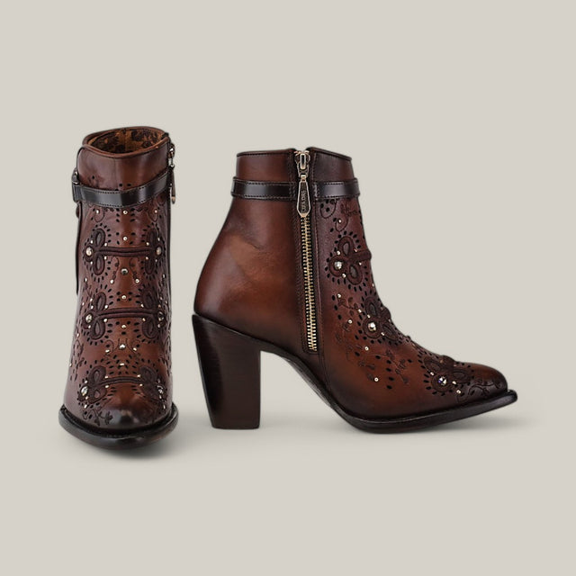 The Honey Embroidery & Studs & Harness - Round Toe - CU637 boots feature brown leather with honey embroidery and floral cut-outs. They include zippers, straps, subtle studs, and chunky high heels, elegantly displayed on a plain beige background.