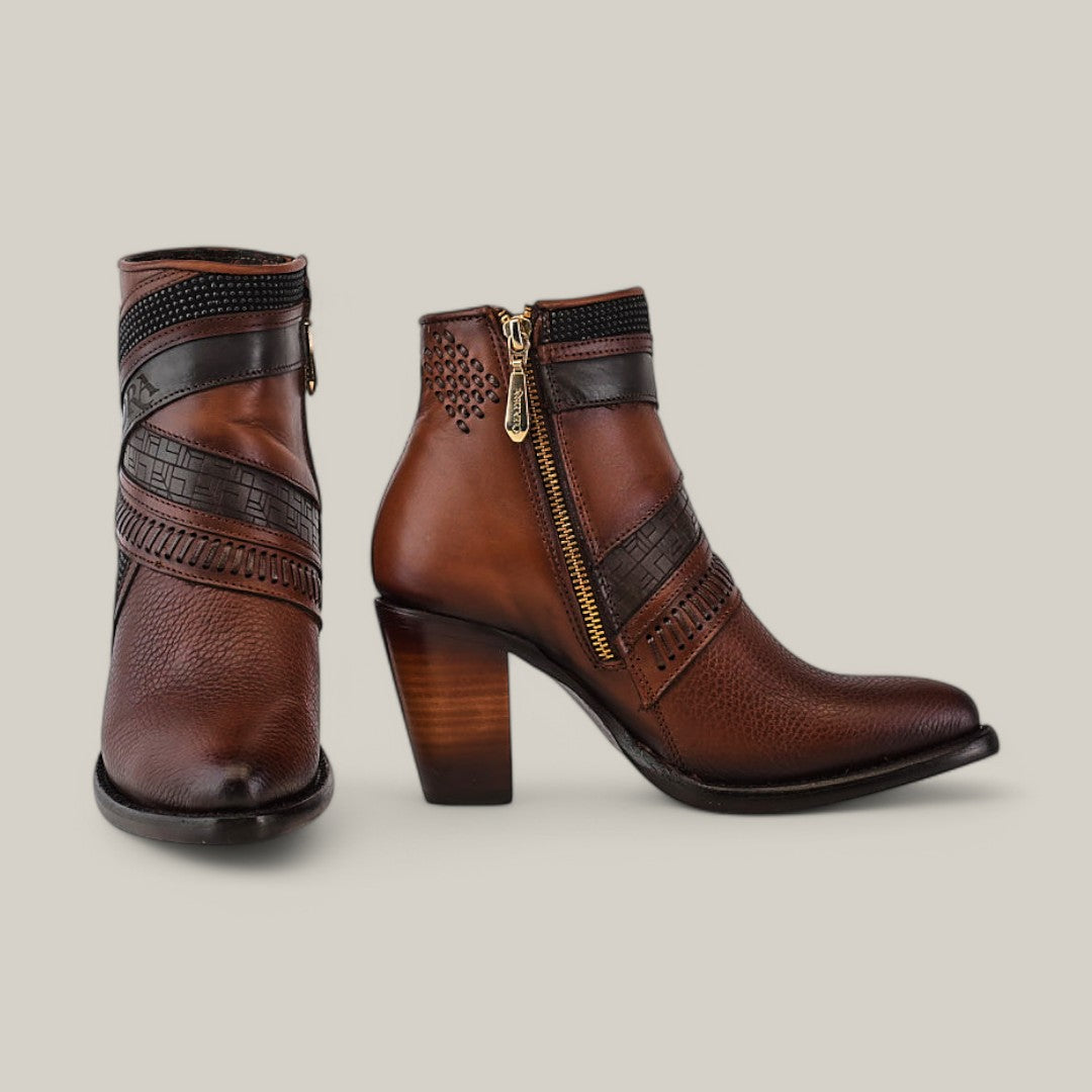 Meet the Honey Laser & Woven CU619 boots: brown leather ankle boots boasting block heels, black decorative straps, a zipper, and embossed patterns. Set against a beige backdrop, these womens boots embody style and elegance.