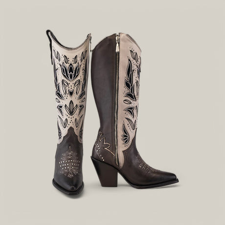 A pair of CU781 snip-toe cowboy boots with dark brown leather and intricate black and cream Tokio Gray embroidery, featuring side zippers, decorative stitching, chunky heels adorned with subtle studs. They are displayed side by side on a neutral background.