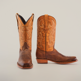 A pair of Azkar Tan - Wide Cutter Toe cowboy boots with intricate stitching is displayed against a plain white background. Made from premium cowhide leather, one boot stands upright while the other shows off its sole, emphasizing the detailed design.