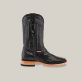 The Exotic Python - Black - Square Toe boot showcases intricate patterns on a textured python leather surface, with a wooden sole and small decorative emblem. It features a pull strap at the top and a red tag near the ankle.