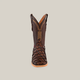 The Exotic Piraruco Fish boot, in brown, features intricate patterns and stitching. Made from glossy pirarucu leather, it stands upright with a square toe and pull tabs, embodying Western fashion allure with detailed craftsmanship.