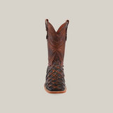 A single Exotic Piraruco Fish - Rustic Cogñac - Square Toe cowboy boot is shown from the front against a plain background. Made of Piraruco fish leather, it features intricate stitching and a textured lower surface with pull straps on either side. The leather boasts a rich brown color.