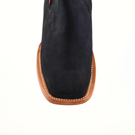 Top view of the Prime Suede Black Square Toe boot, showcasing a black suede upper, brown leather sole with edge stitching, set on a plain white background. This design embodies a sleek, modern cowboy fashion style with its understated elegance.