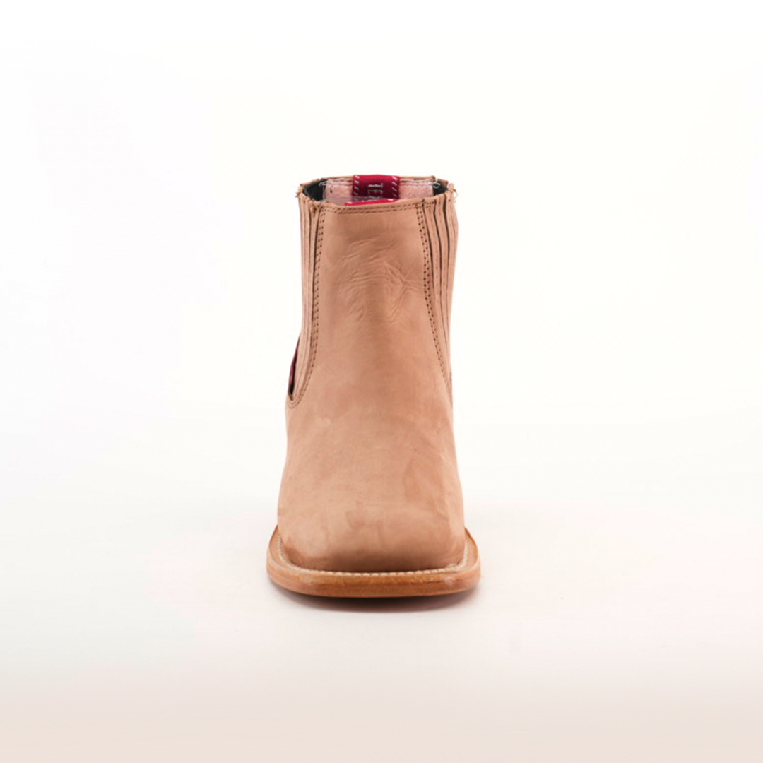 The Prime Suede Sand Square Toe ankle boot is shown facing forward on a white background, highlighting its smooth texture and contrasting red interior lining—ideal for any fashion-forward wardrobe.