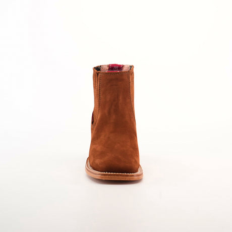 Against a white backdrop, the Prime Suede Brick boot stands out with its brown suede finish and distinctive red plaid lining at the top. Its unique square toe design offers a contemporary flair while maintaining a classic silhouette.