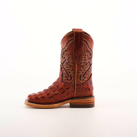 The Caiman Hornback Print Cogñac Square Toe boot stands upright against a white background, showcasing its handcrafted square toe, intricate stitching, premium reptile-patterned leather, wooden heel, and side pull straps.