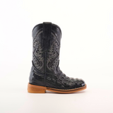 The Caiman Hornback Print Black Square Toe boot features a single intricate shaft pattern and luxurious ostrich leather texture. Its brown sole and heel enhance its elegance against a plain white background, showcasing the artistry of handcrafted boots.