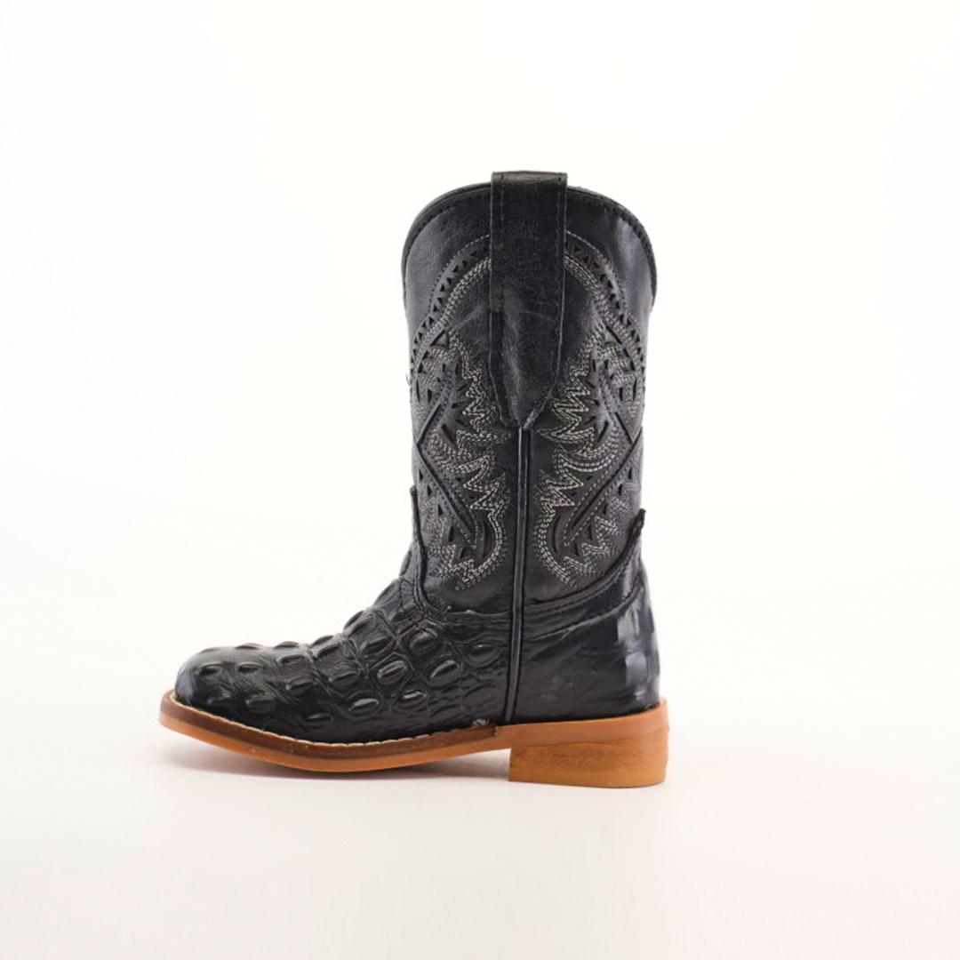 A single handcrafted Caiman Hornback Print Black Square Toe cowboy boot sits against a plain white background. Made from premium leather, it boasts intricate patterns, textured designs, a high shaft, and is complemented by a sturdy wooden heel.