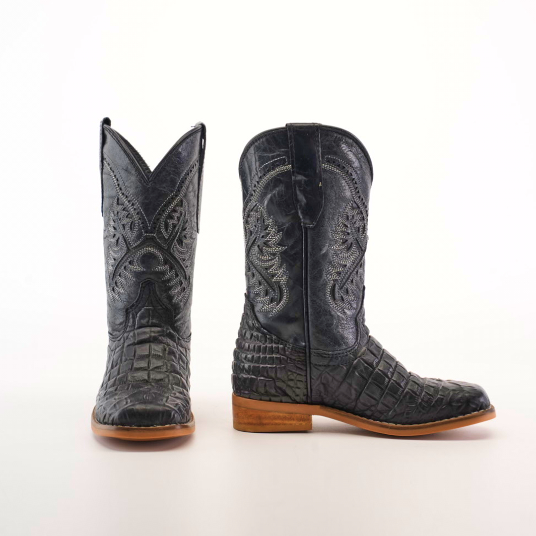 A pair of Caiman Belly Print Black Square Toe cowboy boots featuring intricate stitching and a luxurious texture. Displayed with one boot facing forward and the other in profile against a plain white background, they are perfect for true cowboy enthusiasts.