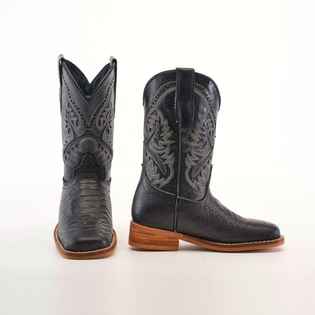 The Python Print Black Square Toe cowboy boots feature intricate white embroidery on black cowhide leather with a python print. One boot faces forward, and the other is seen from the side, showcasing wooden heels against a plain white background.