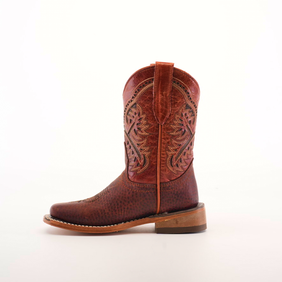 The Cheyenne Shedron Square Toe is a brown cowboy boot crafted from genuine cowhide leather, featuring intricate stitching on the shaft, a handy pull strap, and a solid wooden heel. Its showcased against a plain white background.